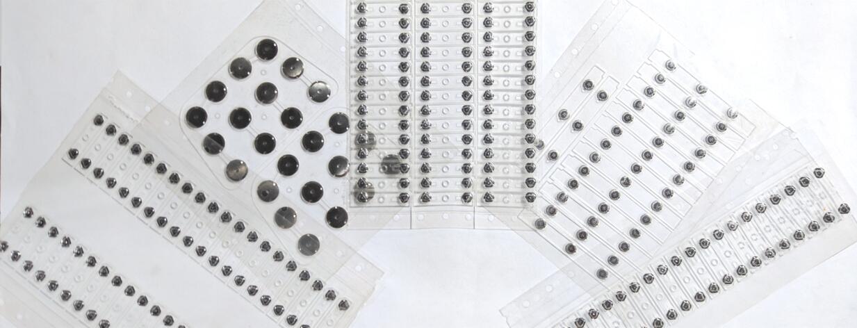 A group of plastic plates with black dots